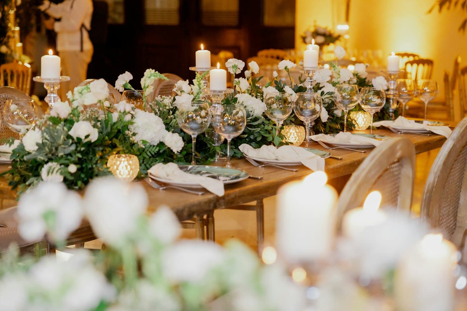 Candlelit wedding reception table set for service